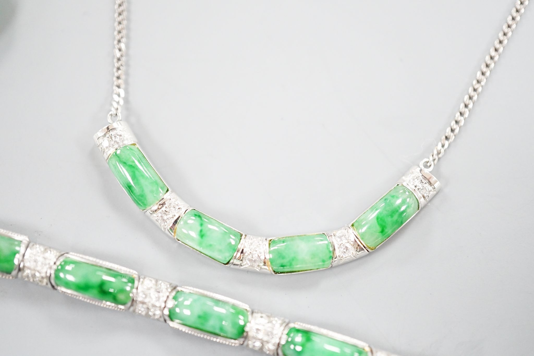 A modern white metal (stamped 850), jade and diamond cluster set bracelet, approx. 15.5cm, with a matching ring, size O and necklace, 38cm